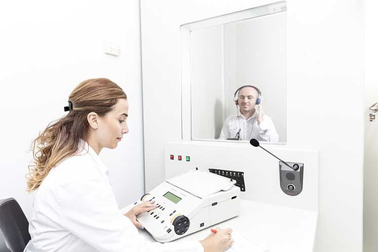 Image show man taking a hearing test