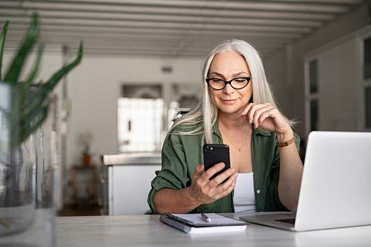 Image show woman looking at her phone