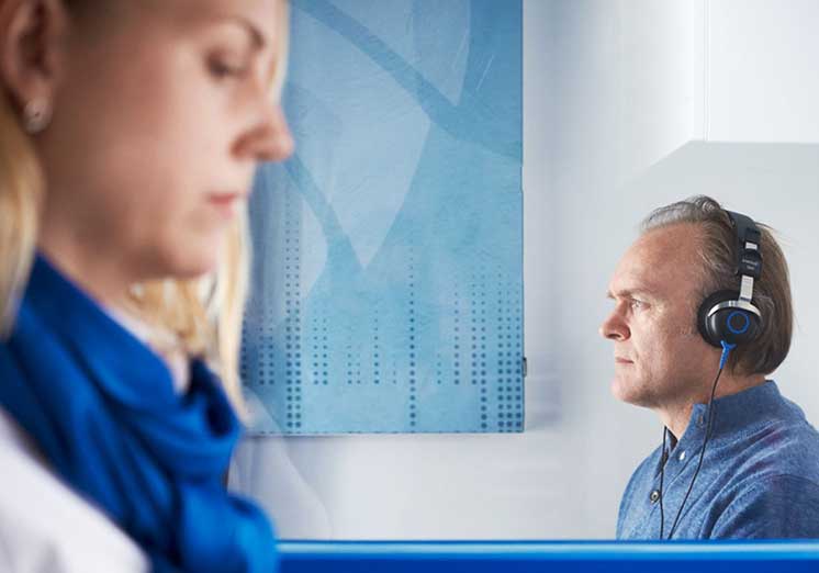 Image show man having a hearing test