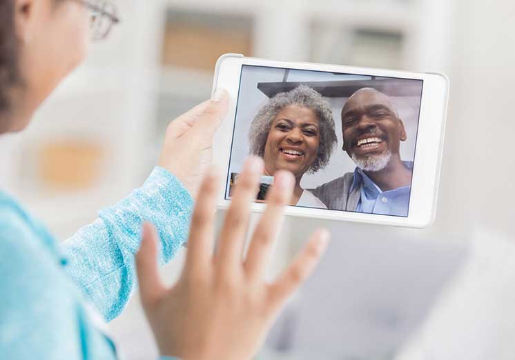 Image show woman have a Facetime call with happy couple