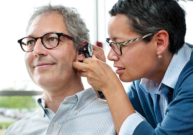 Image show man having an ear examination