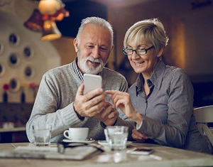 Image show couple looking at a phone