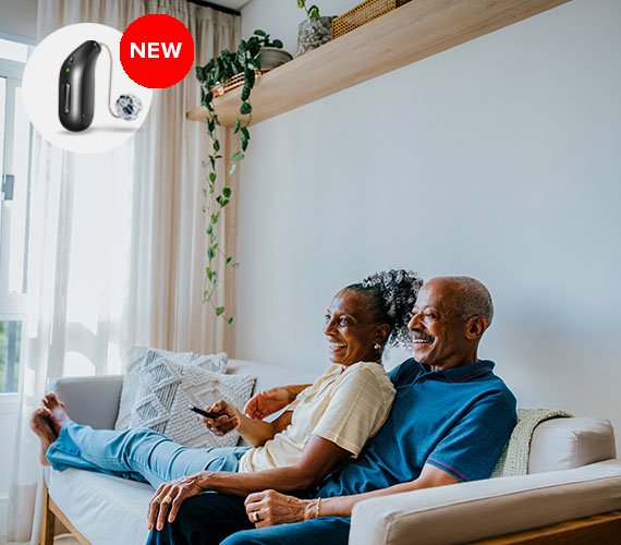 couple sitting and using hearing aid oticon intent