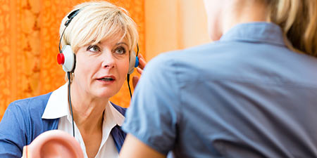 Image show woman taking a hearing test