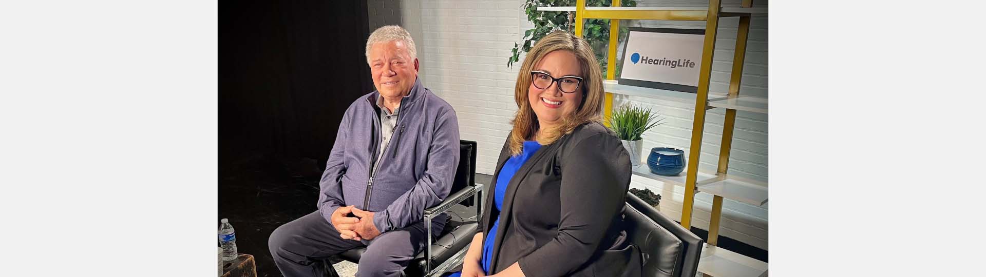 William Shatner and Dr. Rose sitting in a studio smiling at the camera