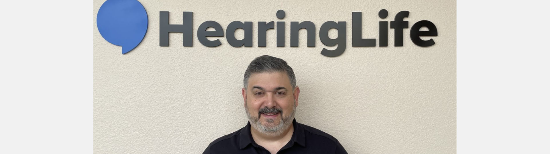 Tod Borges under a HearingLife sign