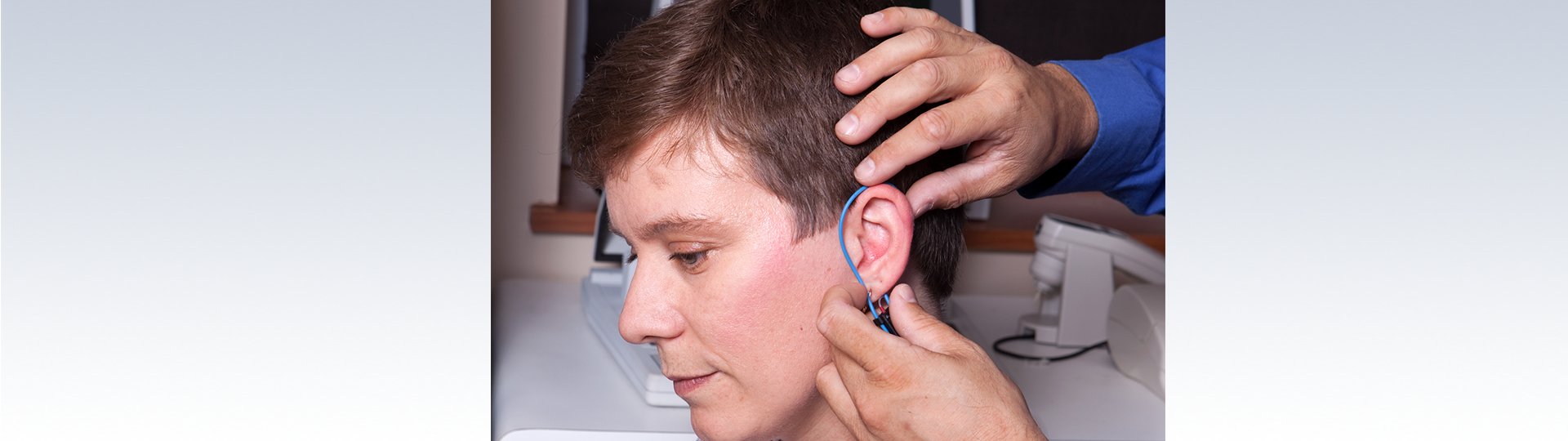 woman getting real ear measurements taken