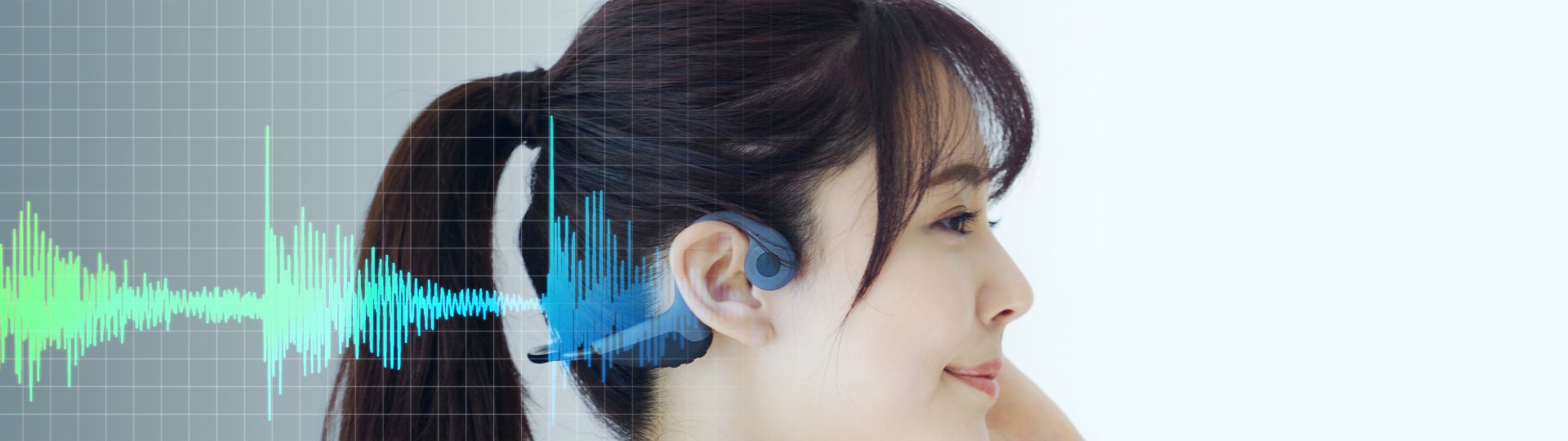 a woman with a bone conduction headphone and soundwaves overlaying the picture