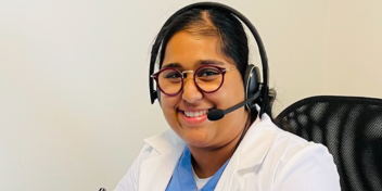 Dr. Sobun smiling at the camera wearing a headset