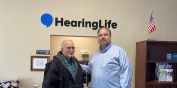 Jerrys magic of giving back photo with Hearing instrument specialist Mike Massie