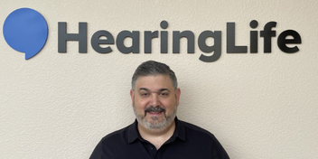 Tod Borges under a HearingLife sign