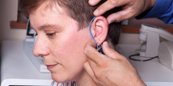 woman getting real ear measurements