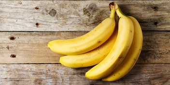 banana bunch on a wood background