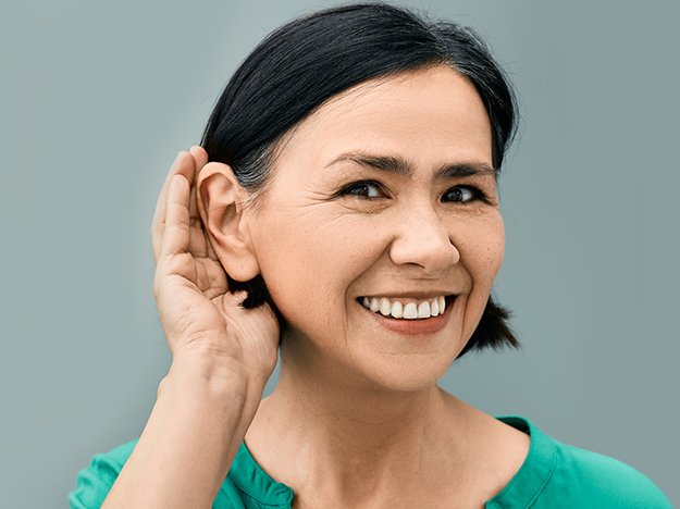woman with hand next to her ear