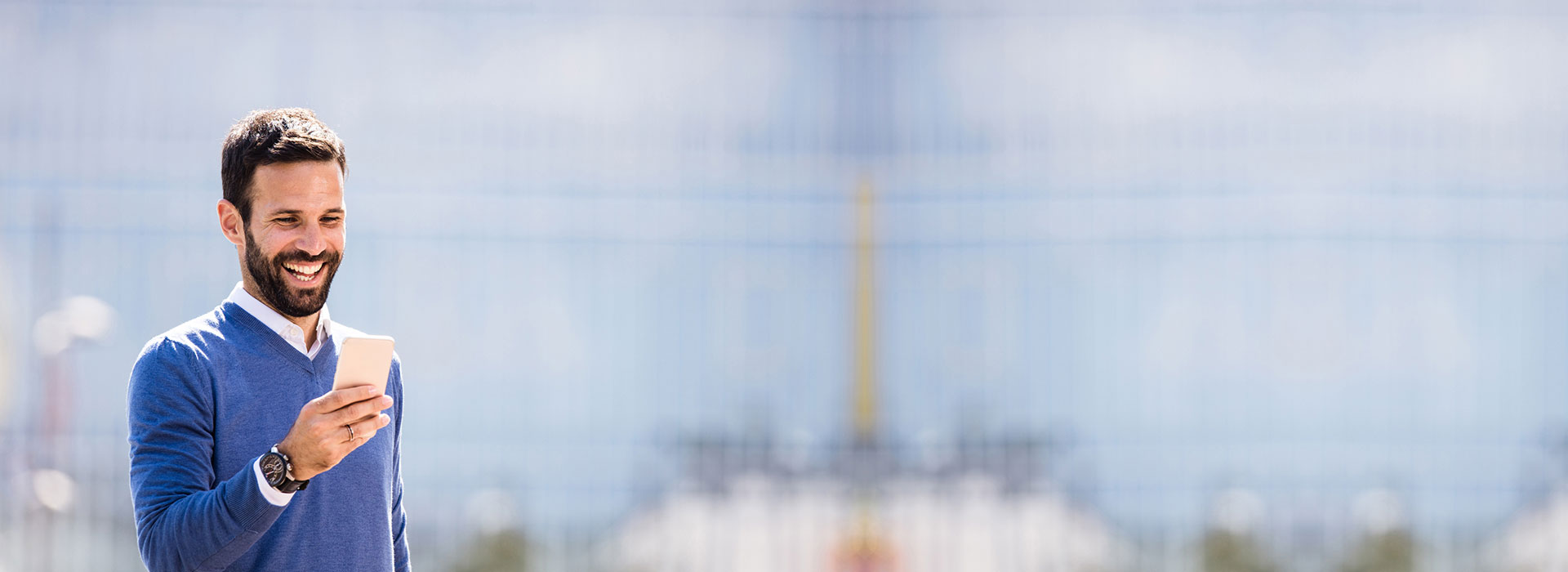 Image show happy man looking at his phone