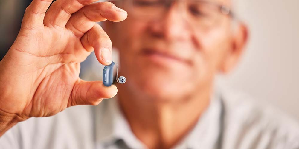 Person holding a hearing aid