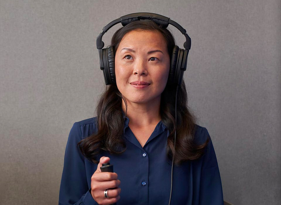 Woman wearing headphones taking hearing test