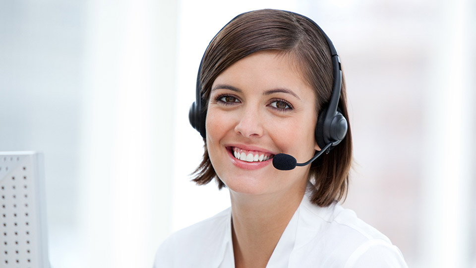 Image of woman in callcenter taking a call with headset on