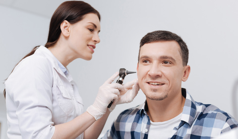 Man getting hearing assessment by audiologist