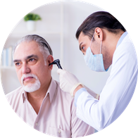 Person having ears checked by hearing care provider