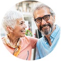 Happy couple wearing Oticon Own hearing aids