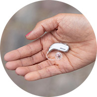 Image show hand hold a hearing aid