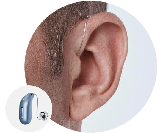 Image shows man wearing receiver-in-the-ear hearing aid