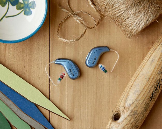 Image shows behind-the-ear hearing aids with other objects