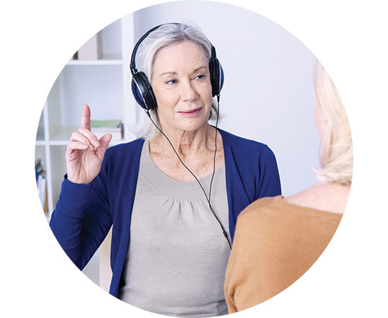 Image show woman with headphones having a hearing test