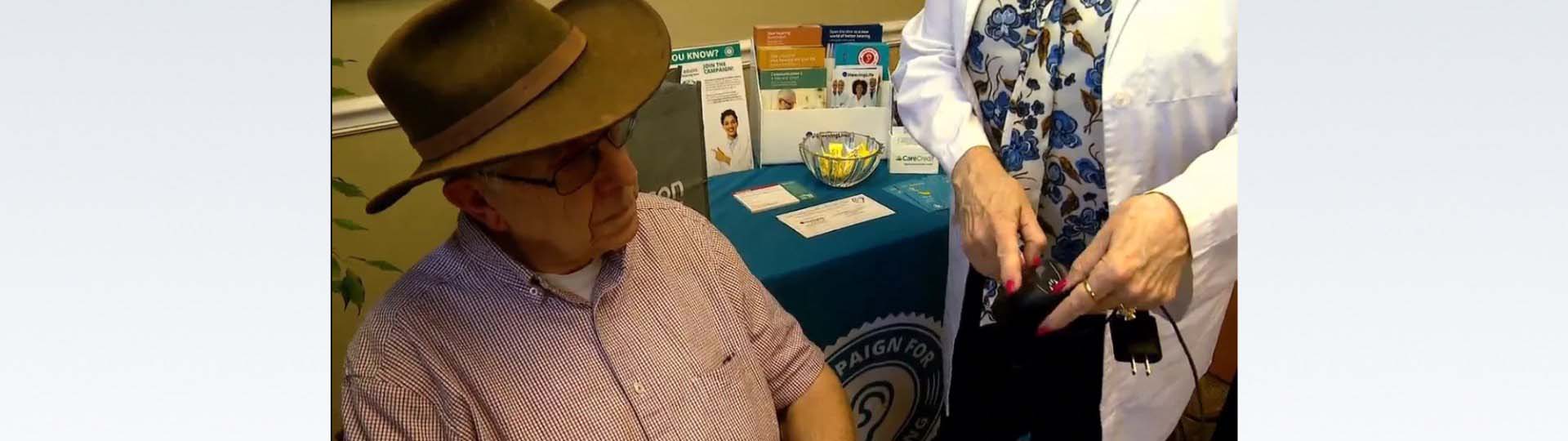 Isaac Allison receives his free hearing aids from The Campaign for Better Hearing