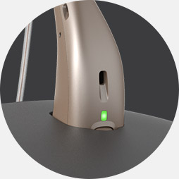 Image shows close up with hearing aid in the charger