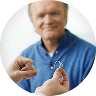 Image show hand holding a hearing aid