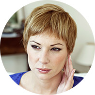 Image shows woman with discomfort in her ear