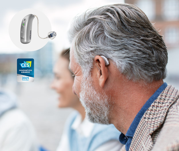 Image shows person wearing Oticon More hearing aids