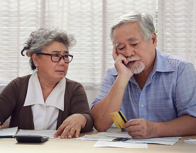 image shows man and woman talking and looking at a paper