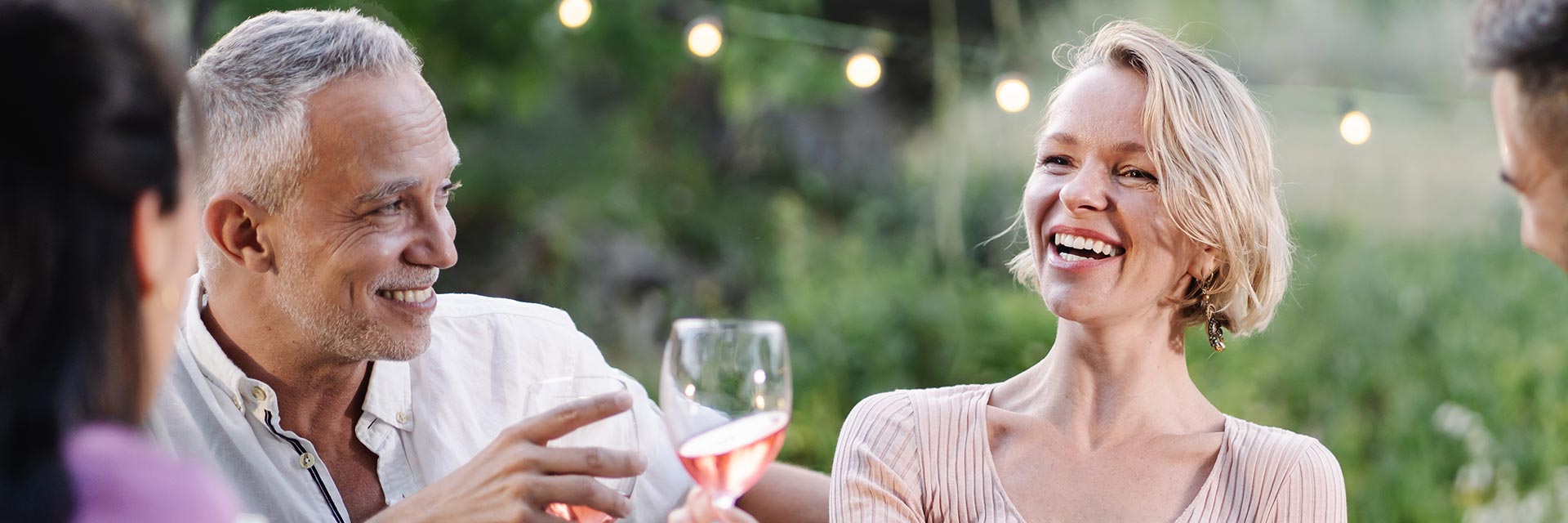 Image shows a happy man at a dinner